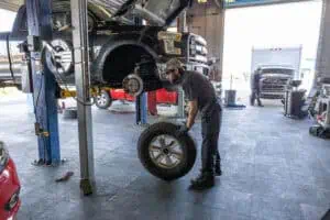 technician performing a tire rotation