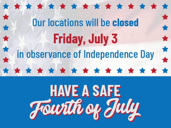 Sign announcing closure on July 3rd for Independence Day with patriotic colors and stars.
